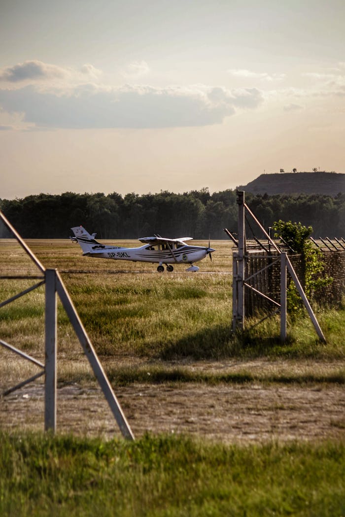 ours-journey Small aircraft on a grassy field in rural Warsaw, Poland during summer.