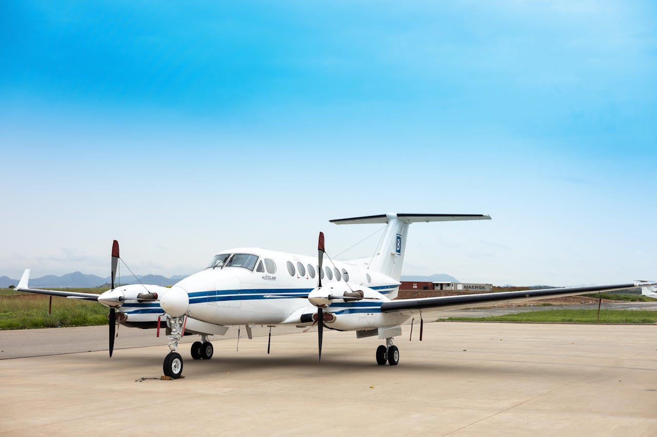 services-img A private airplane sits on an airstrip under a clear blue sky, ready for departure.