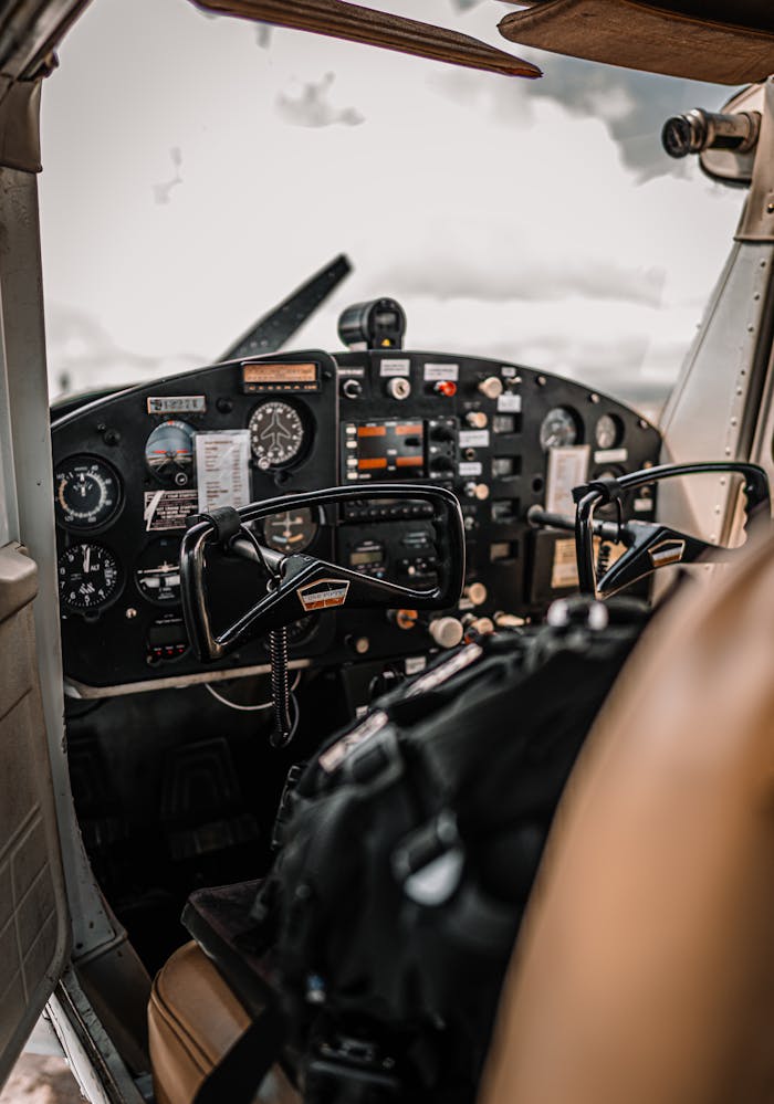 services-04 Control panel and yokes of modern light aircraft parked on aerodrome under cloudy sky