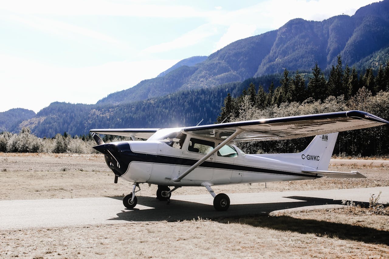 services-03 Cessna aircraft resting on a scenic mountain runway on a clear day.